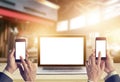 Businessman with smartphone in hands and laptop computer blank screen