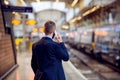 Businessman with smartphone, making a phone call, underground pl Royalty Free Stock Photo