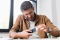 Businessman with smartphone removing damaged touchscreen