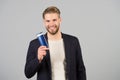 Businessman smile with shampoo or gel bottle in hand, spa. Man with stylish hair, haircut, salon. Mens hygiene, grooming, beauty. Royalty Free Stock Photo