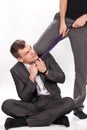 Businessman smiling while being pulled by tie