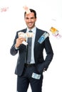 Businessman smiling in falling money