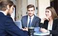 Businessman smiling happily as his business partner finally signing important contract. Royalty Free Stock Photo