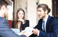 Businessman smiling happily as his business partner finally signing important contract. Royalty Free Stock Photo