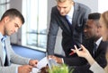 Businessman smiling happily as his business partner finally signing important contract. Royalty Free Stock Photo