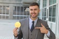 Businessman smiling while holding a Bitcoin Royalty Free Stock Photo