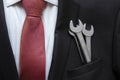 Businessman with spanner in suit pocket. Business creation concept. Auto repair business concept.