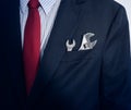 Businessman with spanner in suit pocket