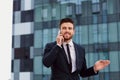 Businessman speaks on the phone outdoors Royalty Free Stock Photo