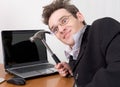 Businessman in spectacles gone mad with a hammer Royalty Free Stock Photo