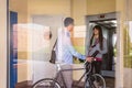 Businessman and sportive girl waving behind glass Royalty Free Stock Photo