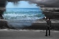Businessman spraying calm sea paint covered dark stormy ocean Royalty Free Stock Photo