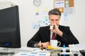 Businessman Spraying Nasal Spray In His Nose