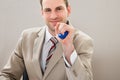 Businessman squeezing blue stressball Royalty Free Stock Photo