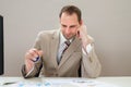 Businessman squeezing blue stressball Royalty Free Stock Photo