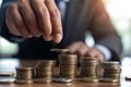 Businessman stacking coins for financial growth concept Royalty Free Stock Photo