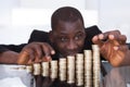 Businessman stacking coins in a row