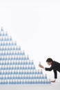 Businessman Stacking Plastic Cups Into Pyramid