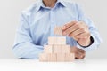 Businessman stacking wooden cube blocks with blank copy space for icons