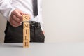 Businessman stacking wooden cubes to spell the word Smile