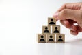 Businessman stacking wooden team blocks