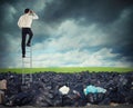 Businessman on a stairs searches far for clean environment. overcome the global pollution problem