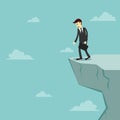 Businessman stand on the edge of cliff and feeling stressed