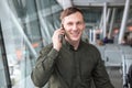 Businessman standing at the airport,talking by cellphone . Royalty Free Stock Photo