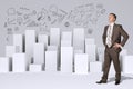 Businessman standing akimbo. Many white cubes with Royalty Free Stock Photo