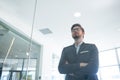 Businessman standing with arms crossed in office Royalty Free Stock Photo