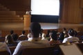 Businessman standing around podium and giving presentation in the auditorium Royalty Free Stock Photo