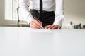 Businessman standing behind his office desk signing a document Royalty Free Stock Photo