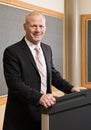 Businessman standing behind podium