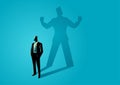 Businessman standing and casting a shadow of a strong superhero Royalty Free Stock Photo