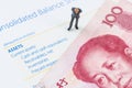 Businessman standing with Chinese banknote on the bala