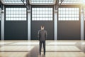 Businessman standing in contemporary hangar interior Royalty Free Stock Photo