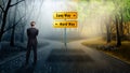 Businessman standing on a crossroad having the options Easy Way and Hard Way Royalty Free Stock Photo