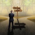 Businessman standing at a crossroad having to decide between `free trade ` and `tariffs ` Royalty Free Stock Photo