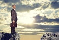 Businessman standing on the edge of rock gap Royalty Free Stock Photo