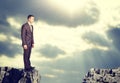 Businessman standing on the edge of rock gap Royalty Free Stock Photo
