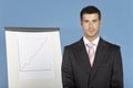 Businessman Standing By Flip Chart Royalty Free Stock Photo