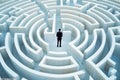 businessman standing at a fork in the road in a maze, looking thoughtful Royalty Free Stock Photo