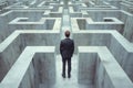 businessman standing at a fork in the road in a maze, looking thoughtful Royalty Free Stock Photo