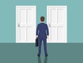 Businessman standing in front closed doors. Royalty Free Stock Photo