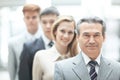 Businessman standing in front of his business team on blurred office background Royalty Free Stock Photo