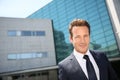 Businessman standing on front of modern building Royalty Free Stock Photo