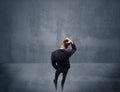 Businessman standing in front of urban wall Royalty Free Stock Photo