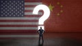 Businessman standing in front of a wall with a questionmark and the flags of the usa and china