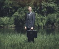 Businessman standing on a grassland Royalty Free Stock Photo