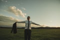 Businessman standing in green meadow with his arms spread widely Royalty Free Stock Photo